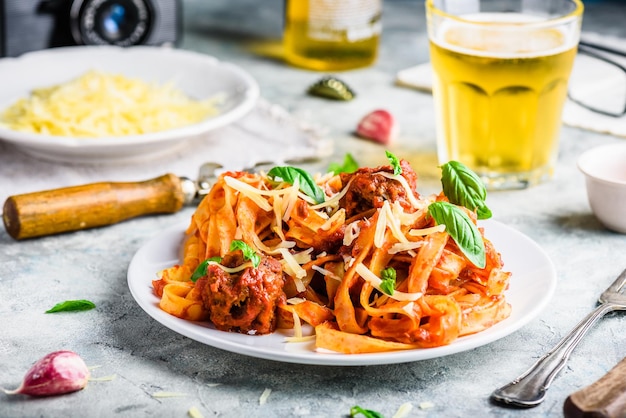 Pasta with mini meatballs tomato sauce and parmesan cheese