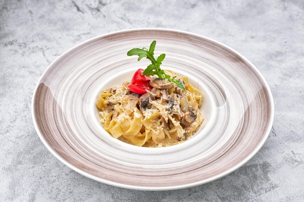 Pasta with mushrooms cheese and tomatoes on a plate