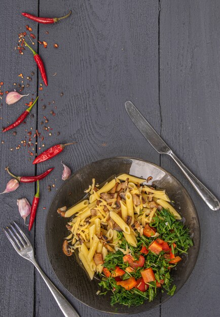 Pasta with mushrooms on a wooden background country style top view