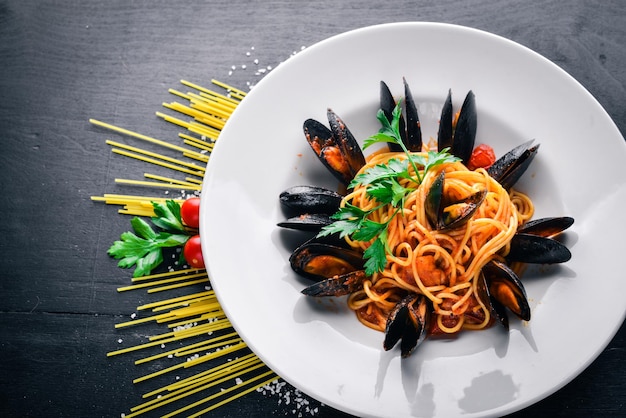 Pasta with mussels and seafood Italian traditional food On a wooden background Top view Free space for your text