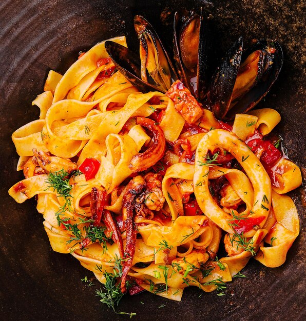 Pasta with mussels squid and octopus closeup