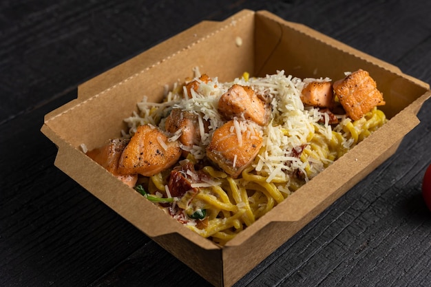 Pasta with salmon and cheese In a box for delivery