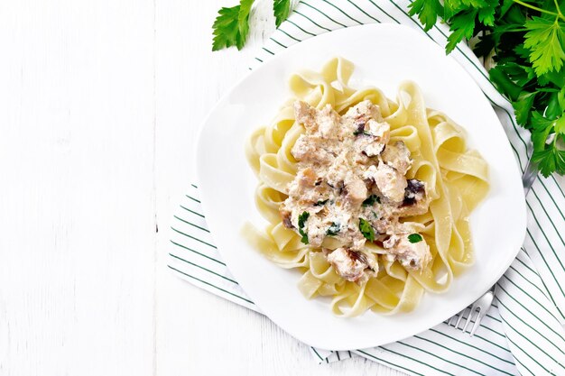 Pasta with salmon in cream on board top