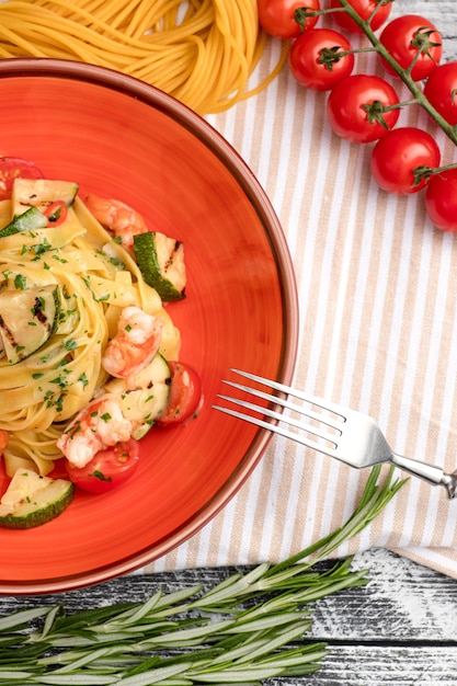 Pasta with shrimp pasta with seafood on a white wooden background top view