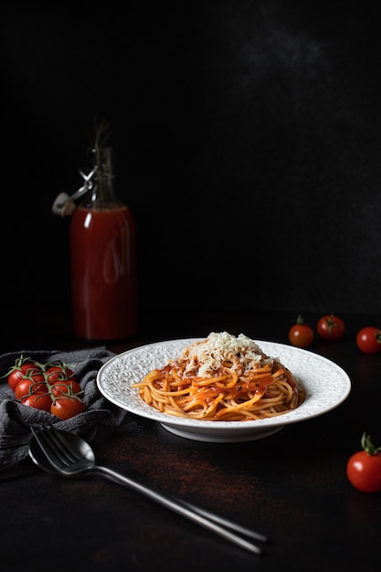 Pasta with tomato sauce and parmesan on a plate