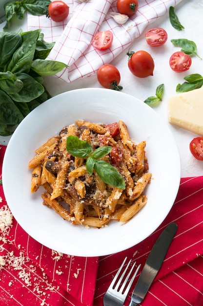 Pasta with tomatoes, parmesan and basil. in a white plate 