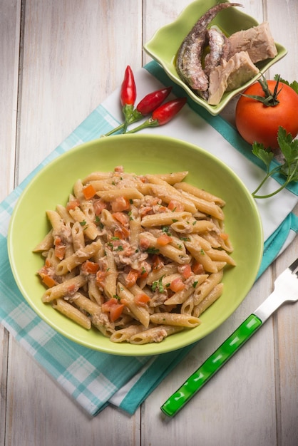 Pasta with tuna anchovies tomato and hot chili pepper