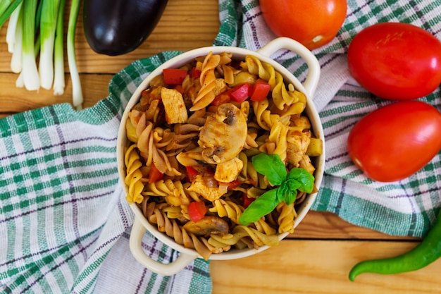 Pasta with vegetable sauce on wooden 