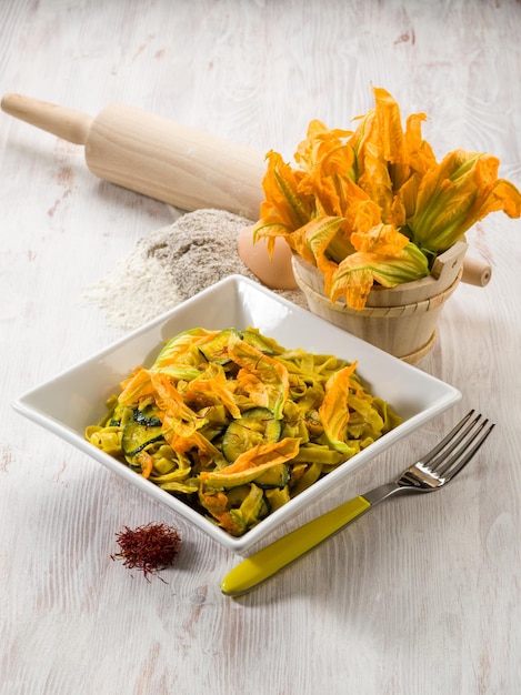 Pasta with zucchinis flower and saffron