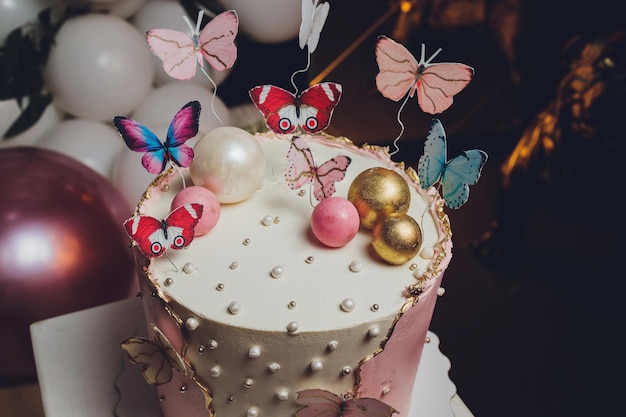 Pastel colors tasty cake with butterfly White yellow pink and blue cream custard White background Selective focus