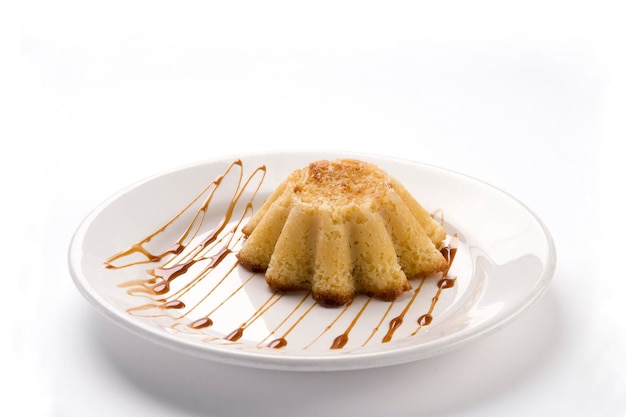 Pastel de elote con cajeta corn pie with burnt milk on a plate on white background food dessert