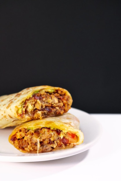 Pastor mexican burrito with meat and hot sauce