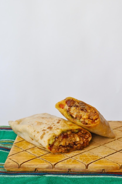 Pastor mexican burrito with meat and hot sauce