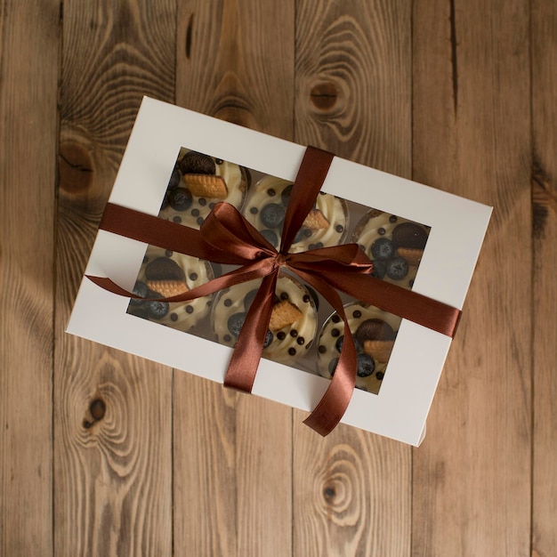 Pastries in a box decorated with a satin ribbon