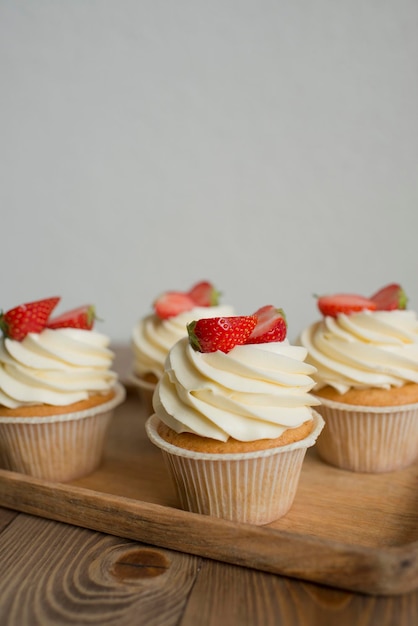 Pastries decorated with strawberries on the table