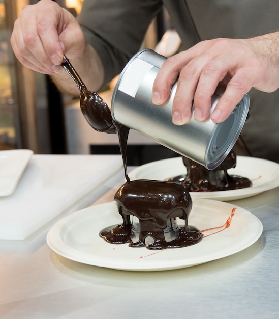 Photo pastry chef decorating, chef preparing desert chocolate cake