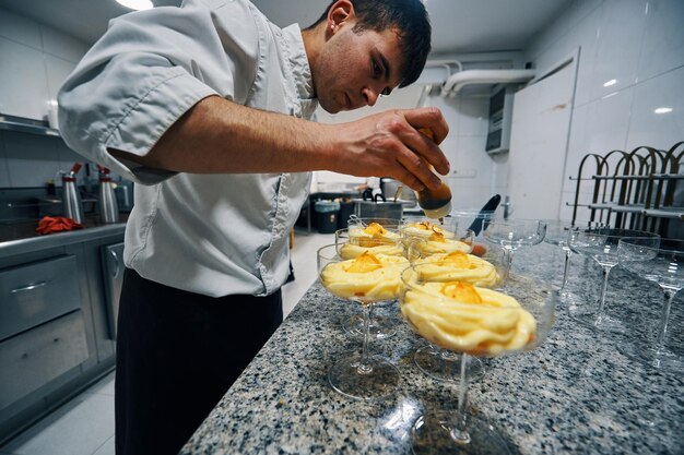 Pastry chef preparing mandarin sherbet dessert