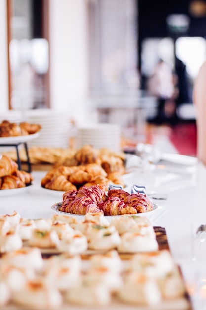 Pastry cookies and croissants sweet desserts served at charity event  food drinks and menu concept a...