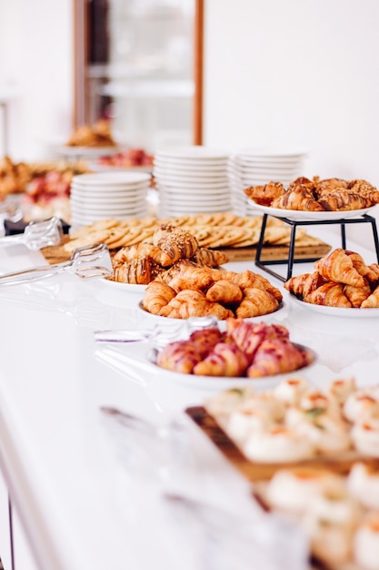 Pastry cookies and croissants sweet desserts served at charity event  food drinks and menu concept a...