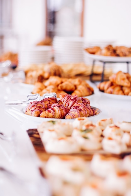 Pastry cookies and croissants sweet desserts served at charity event  food drinks and menu concept a...