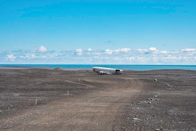 Pathway leading towards plane wreck at black sand beach in solheimasandur