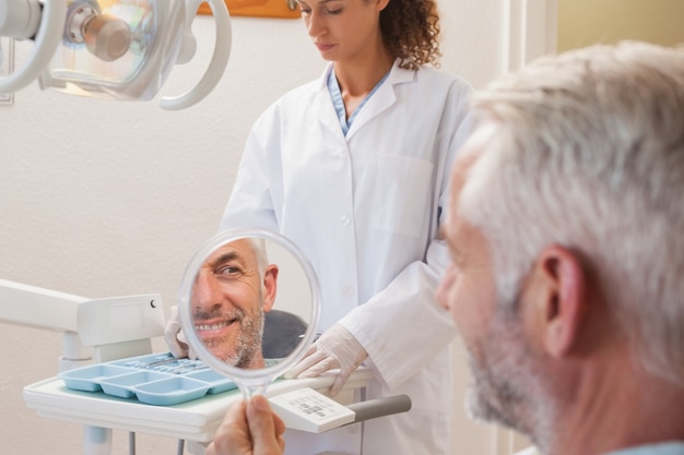 Patient admiring new smile in the mirror