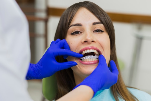 Patient getting invisible retainers at dentist