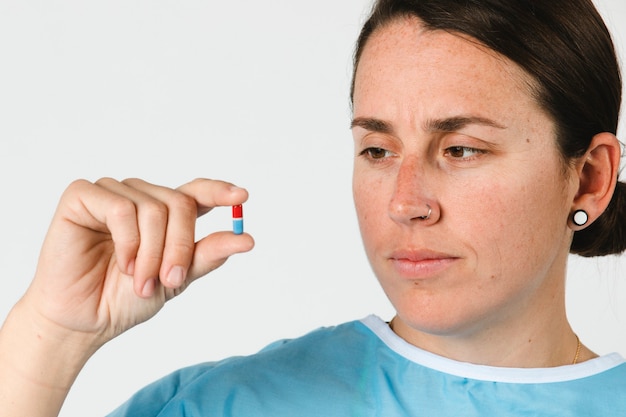 Patient holding a red and blue pill