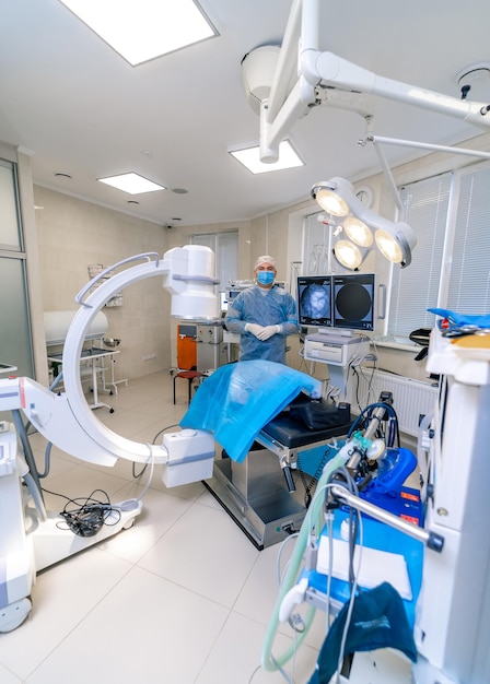 Patient laying in the surgery room before operation. Modern interior with up to date technic. Medicine and surgery concept