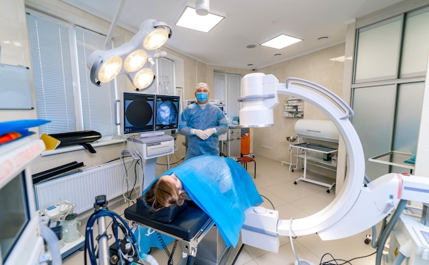 Patient lays in surgery room before operation Modern interior with up to date technic View from above