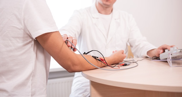 Photo patient nerves testing using electromyography at medical center