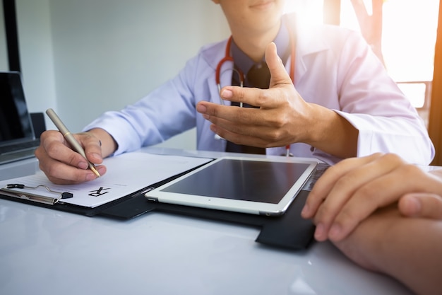 Patient sitting with Doctor for consulting at hospital office