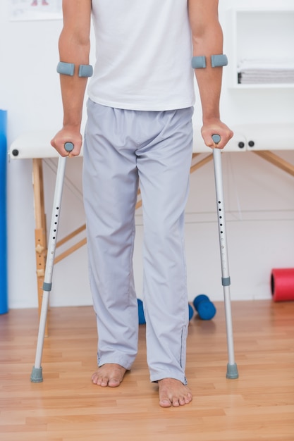 Patient standing with crutch 