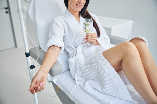 a patient with a catheter in her vein undergoing the medical procedure