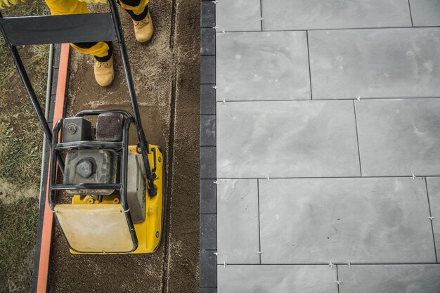 Photo patio brick floor paving and soil compacting