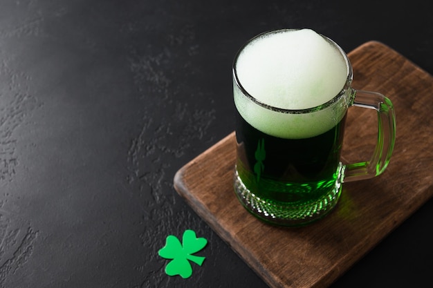 Patrick's day green beer in pint on black background