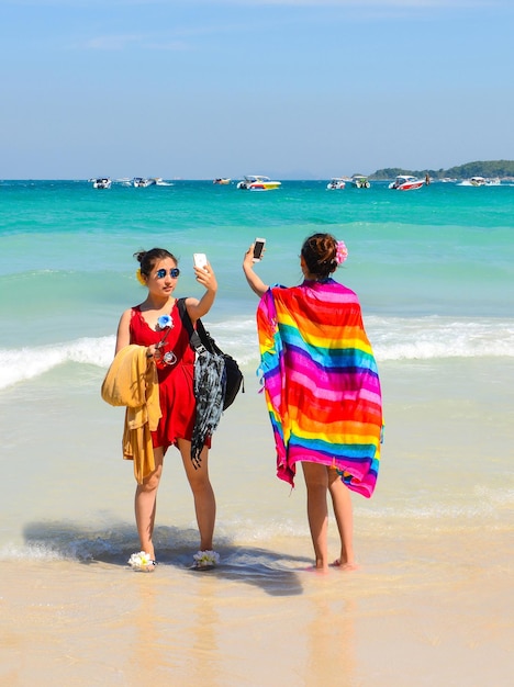 PATTAYA THAILAND DECEMBER 29 2014 Asian womans taking selfie with smartphone on the beach in Koh Larn Larn Island on December 29 2014 in Pattaya Thailand