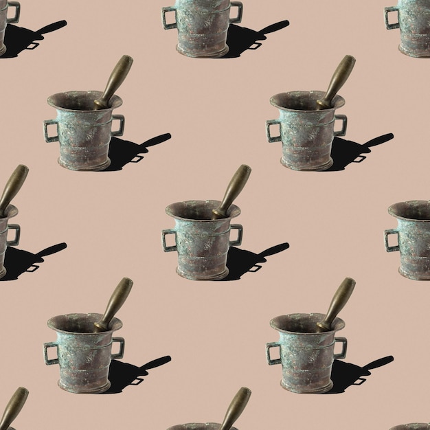 Pattern from a bronze mortar with a pestle on a beige background