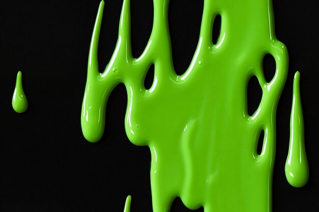 Photo pattern glossy neon green slime dripping on black background