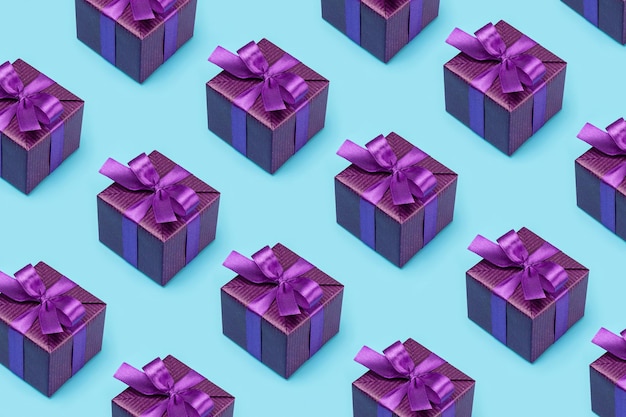 Pattern happy holidays Gift boxes in fancy purple paper copied cloned on a blue background