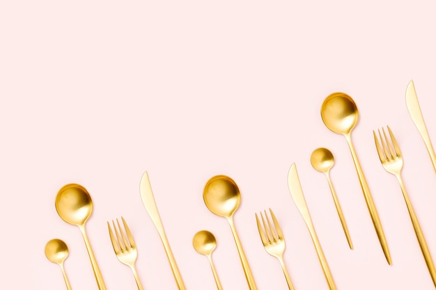 Pattern made of cutlery on pastel background, flat lay, top view. Fashion Minimalist concept.