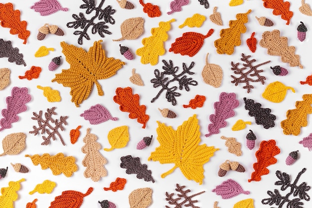 Pattern made of knitting yellow leaves. Autumn background. Fall mood