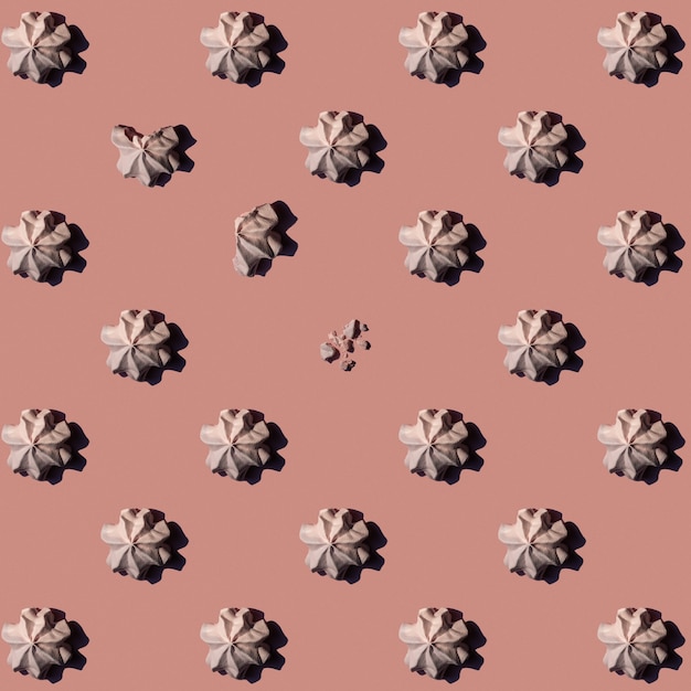 Pattern of meringues on pink background