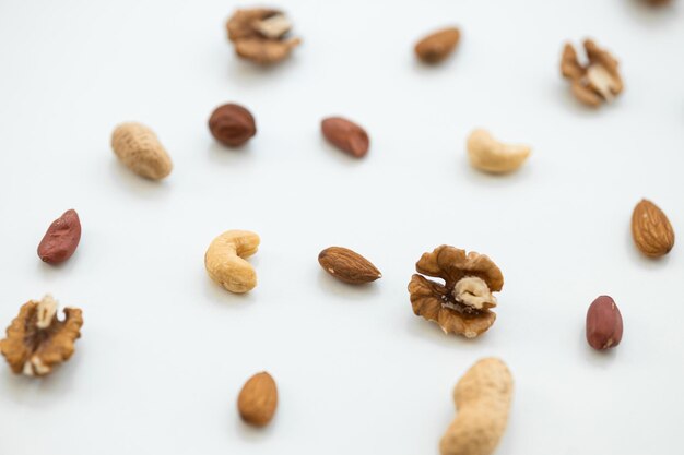 Pattern of nuts mix Cashew peanut hazelnuts walnuts almonds on white background