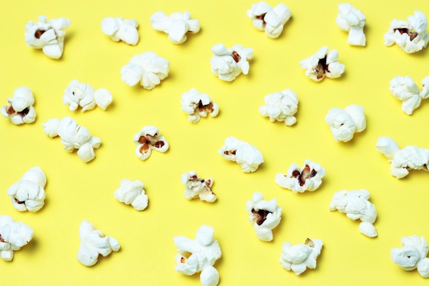 Pattern of popcorn on a yellow background closeup top view texture