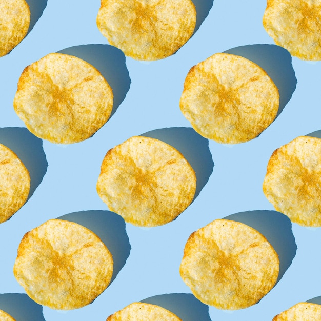 Pattern of potato chips on a blue background

