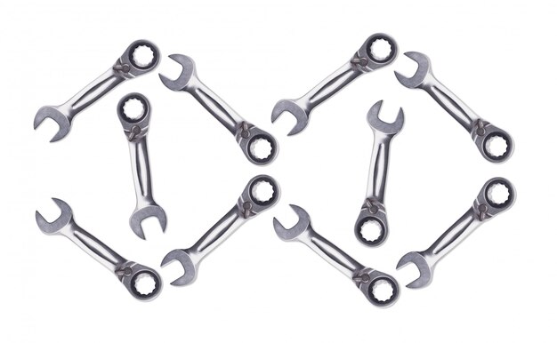 Pattern of Ratchet Wrenches, chromed metal, tool for fixing nuts and bolts. White background isolate view from the top.