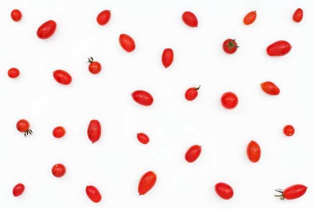 Pattern of red mini tomatoes on white background. Flat lay