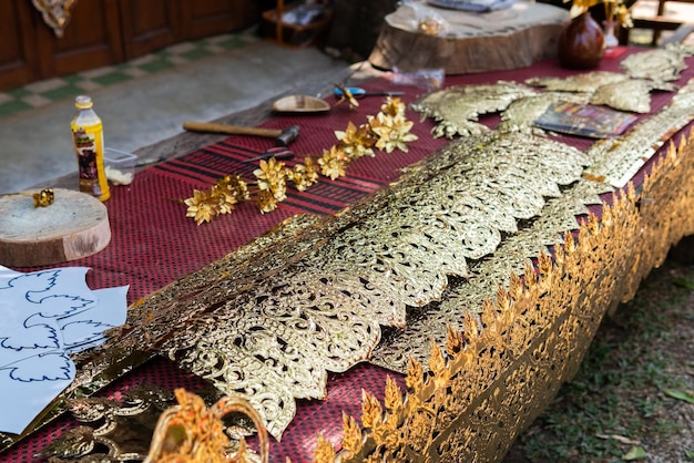 Pattern of silver metal plate with flower carved background Thai style in temple