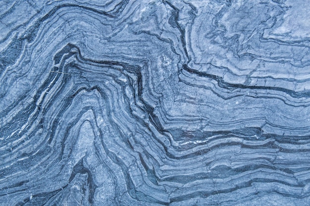 The pattern and surface of the blue, white and black marble walls for the background.